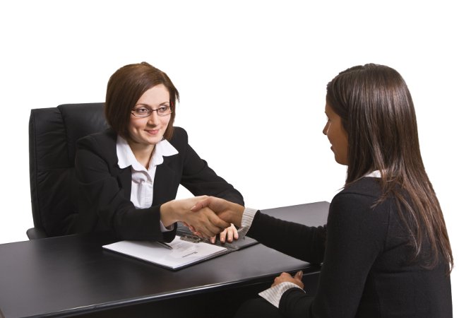 Businesswomen shaking hands in the office.The documents are mine.